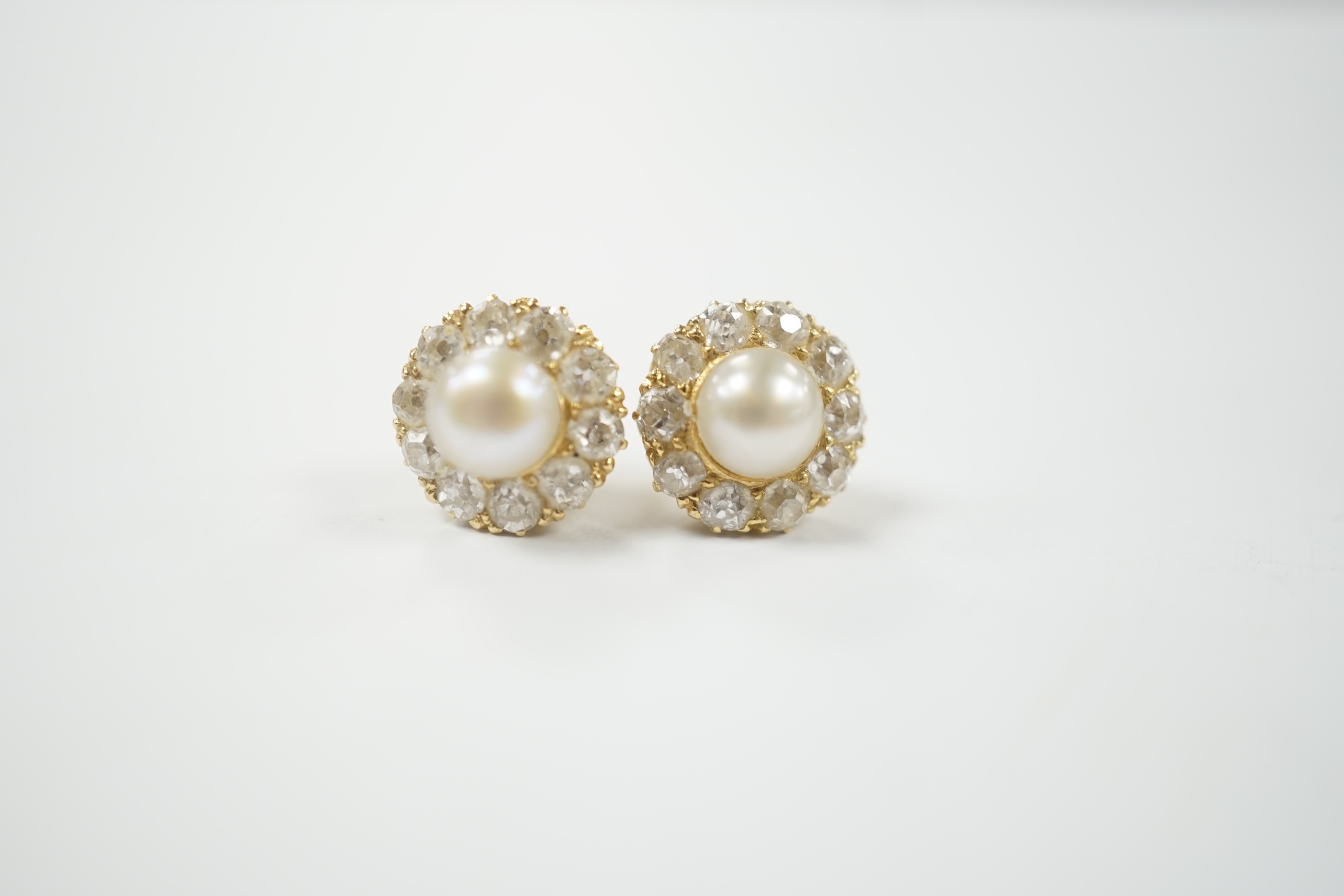 A pair of yellow metal (stamped 18), cultured pearl and diamond cluster set flower head ear studs, diameter 9mm, gross weight 2.9 grams.